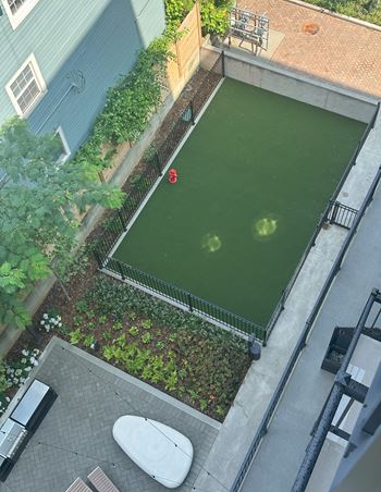 an aerial view of a tennis court in a courtyard